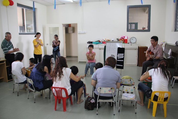 Parents and children in a music and support session